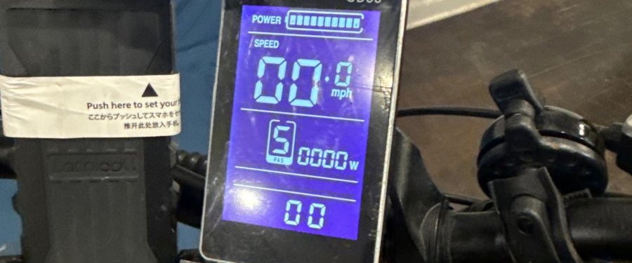 E-bike handlebar display showing battery level and pedal-assist level 5 at Wilson's Long Island City shop