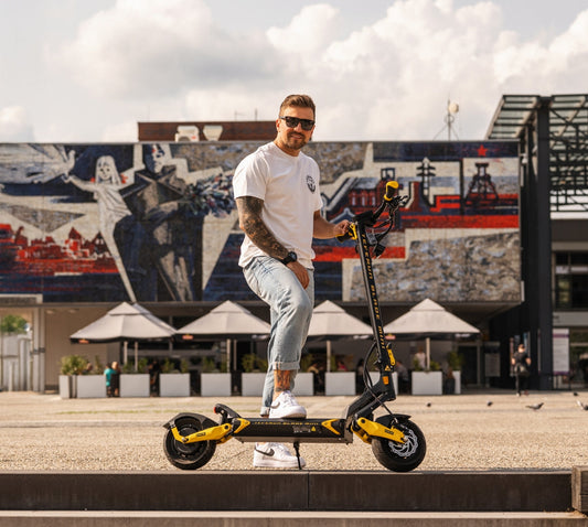 Teverun Blade Mini electric scooter with dual motor, hydraulic brakes, and LED display on rugged aluminum frame