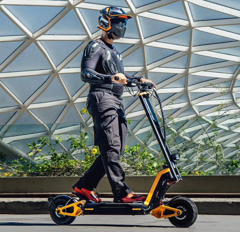 Person riding an electric scooter with a modern architectural background