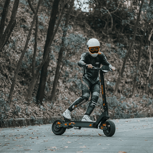 Person riding an electric scooter in a forested area