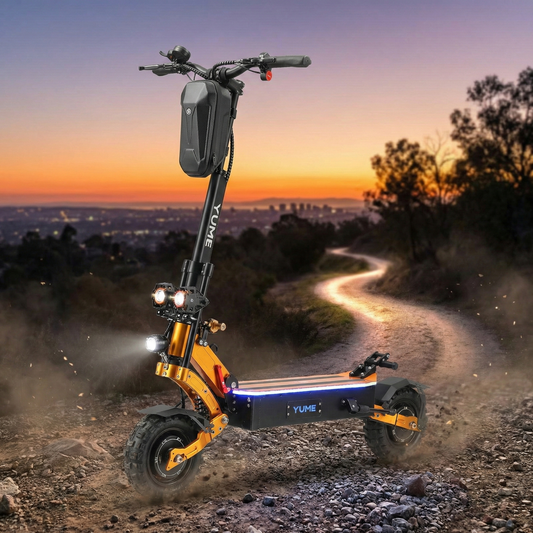 Yuneec electric scooter on a dirt path with a cityscape at sunset