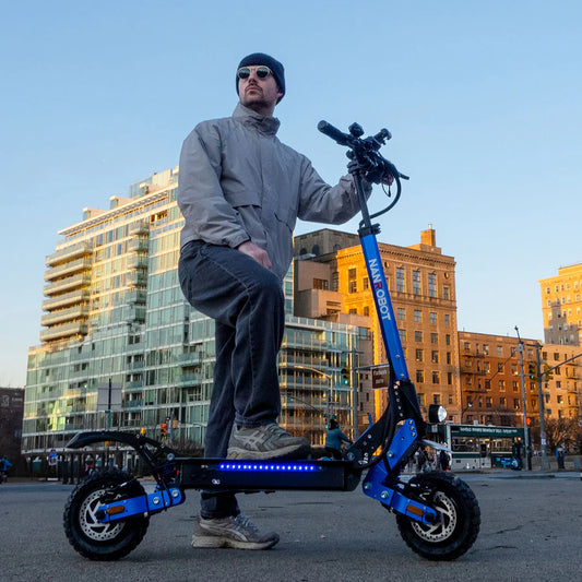 Person holding a blue electric scooter with cityscape in the background