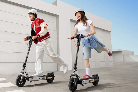 Young professionals enjoying a high-energy ride on a Navee commuter e-bike and scooter combo from Wilson.
