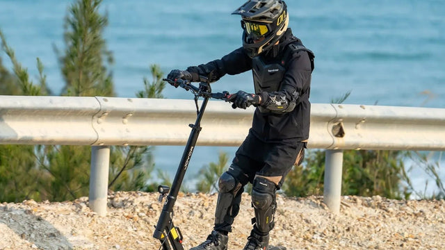 Rider on a Joyor T10 off-road electric scooter on the beach
