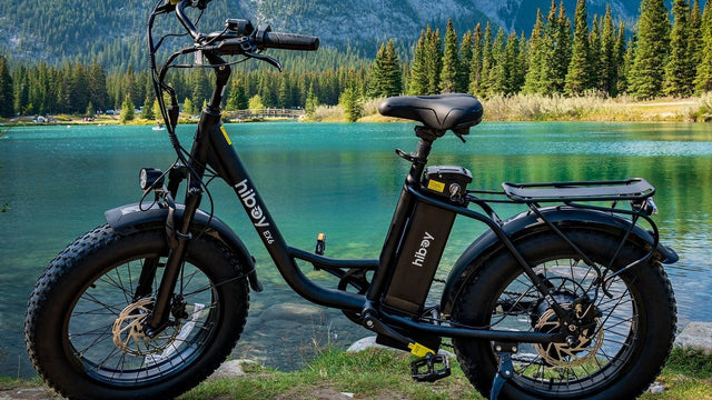 Hiboy EX6 fat-tire e-bike parked by a mountain lake