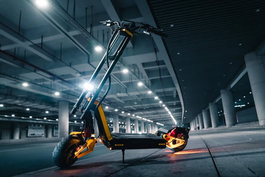 INMOTION RS electric scooter lit up at night under a concrete underpass