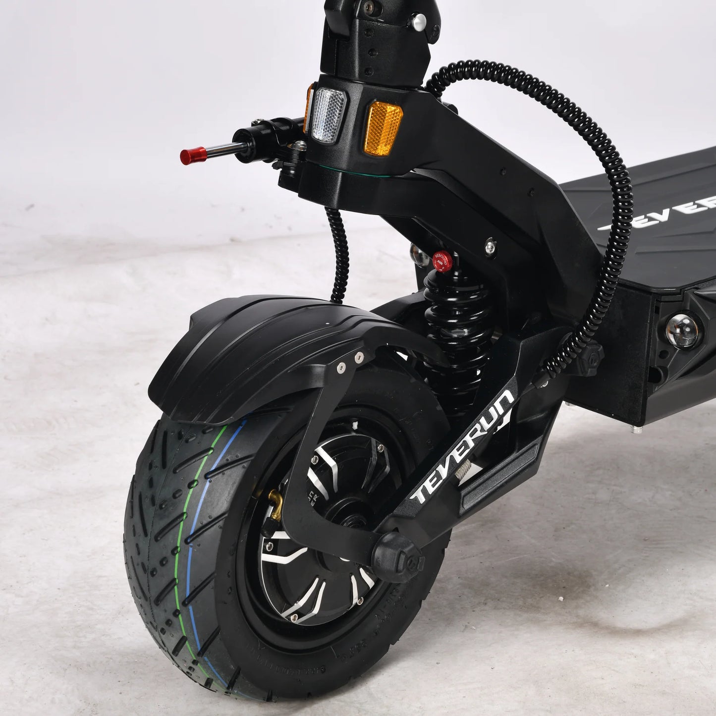 Close-up of a black electric scooter with visible branding on a light gray background