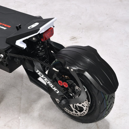 Close-up of a black scooter with visible branding on a light gray background