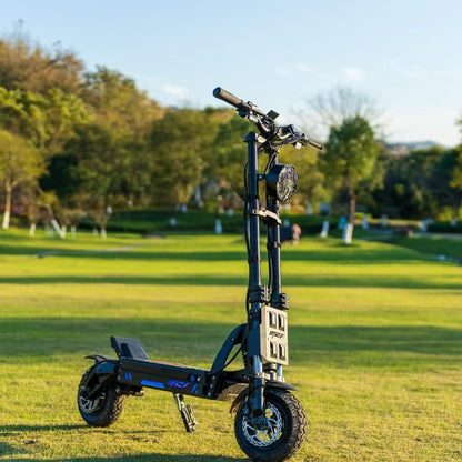 Foldable electric scooter on a grassy field with trees in the background