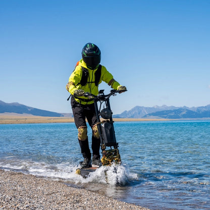 Person riding a hoverboard on a beach with mountains in the background