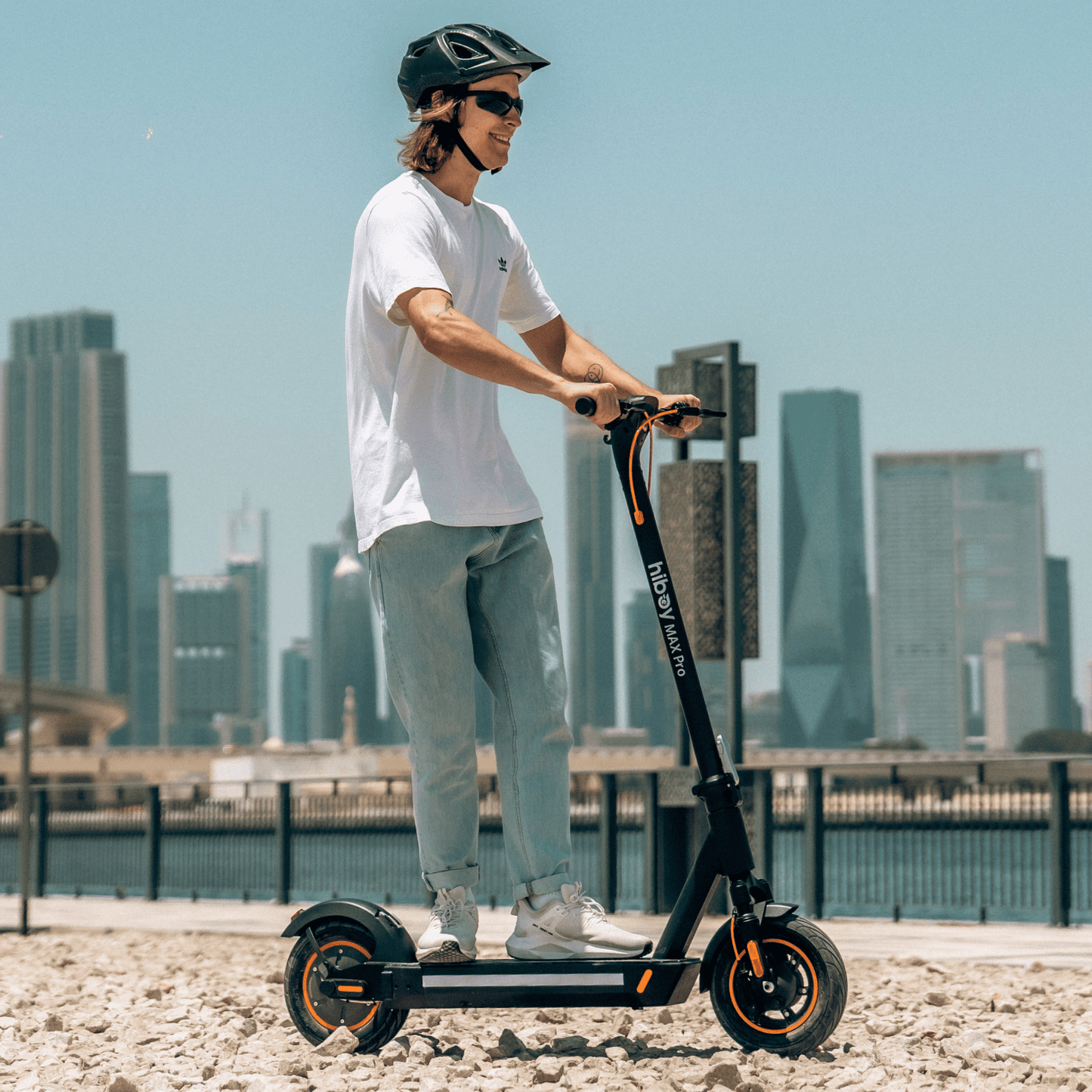 Person riding an electric scooter with a city skyline in the background