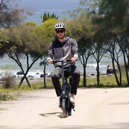 Person riding a scooter near a beach with trees and water in the background
