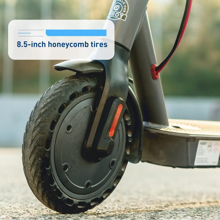 Close-up of an electric scooter wheel with 8.5-inch honeycomb tires, brand 'G-BOY' visible.