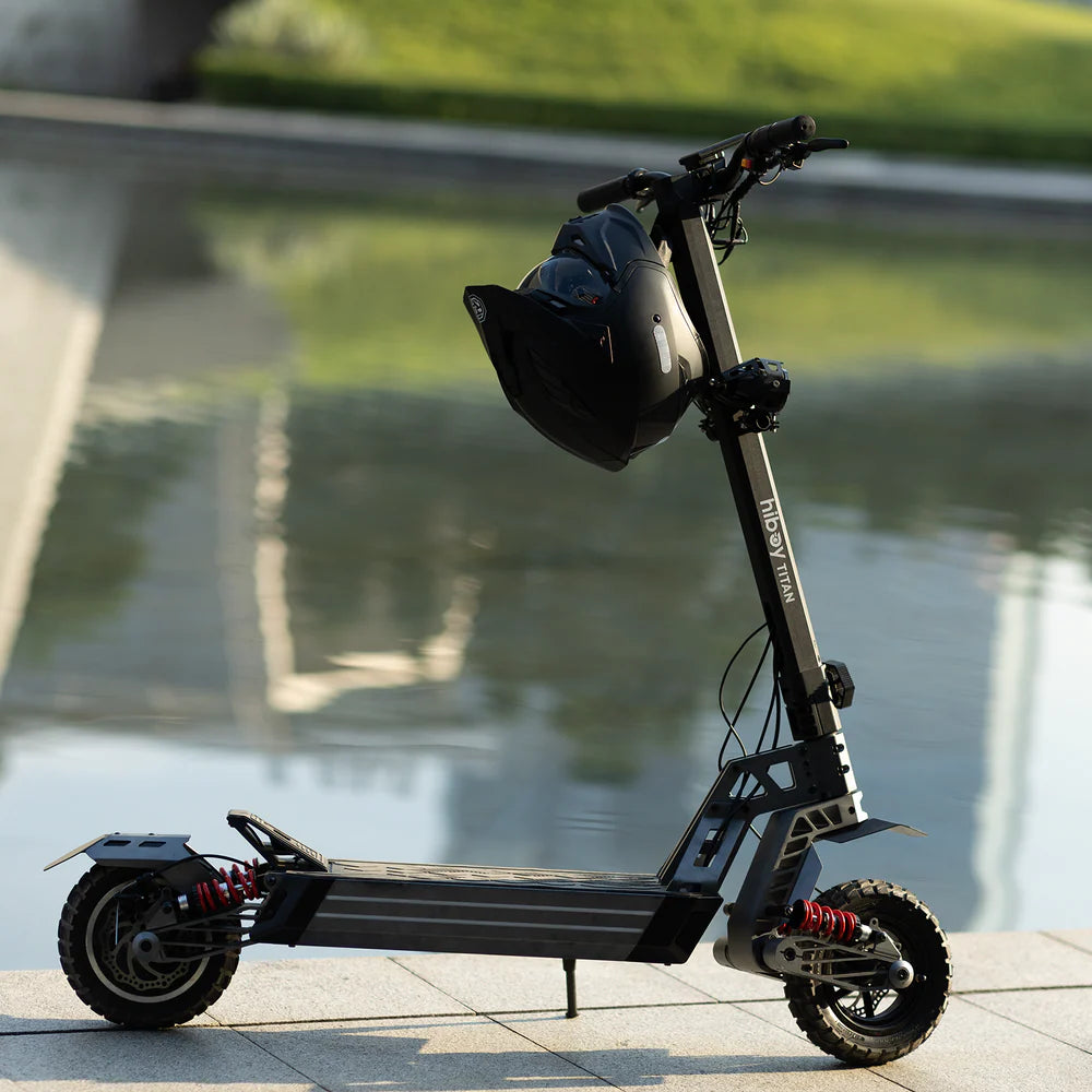 Electric scooter with a helmet on a sidewalk by a body of water