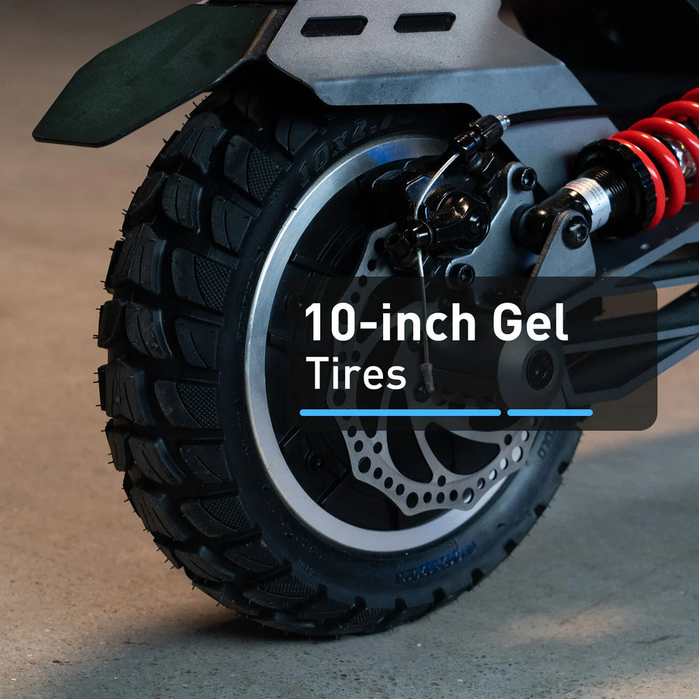 Close-up of a motorcycle wheel with '10-inch Gel Tires' text on a blurred background