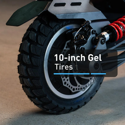 Close-up of a motorcycle wheel with '10-inch Gel Tires' text on a blurred background