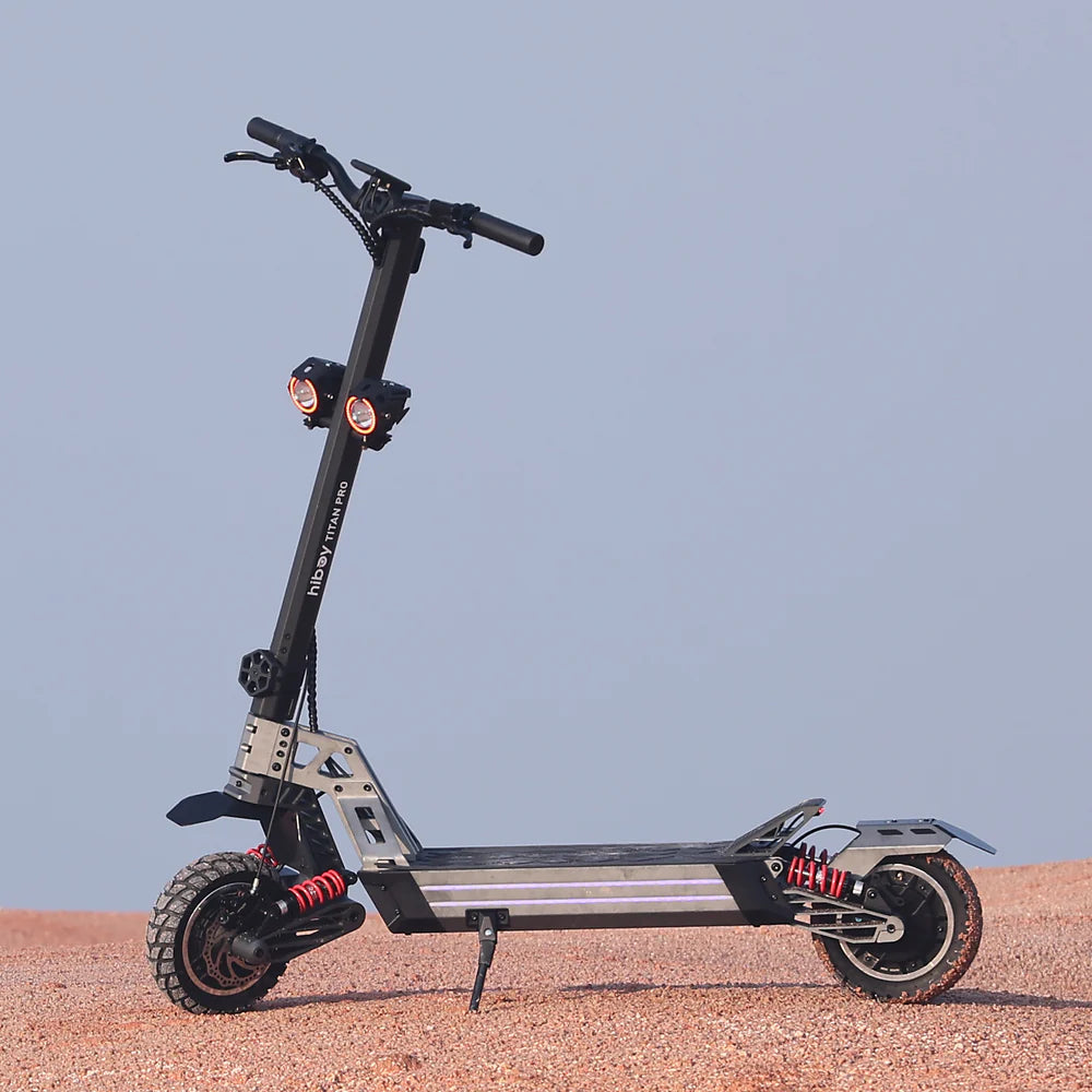Electric scooter on a sandy surface with a clear blue sky