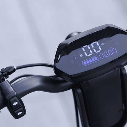 Digital display on a bicycle handlebar with speed and battery indicator.