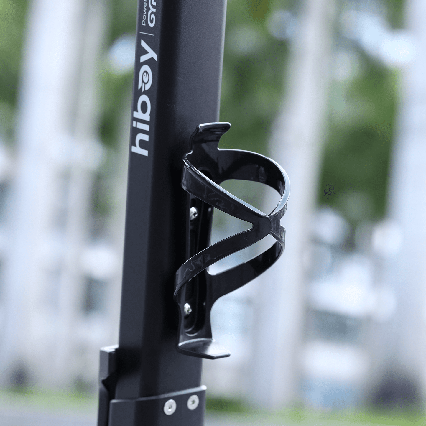 Black bicycle water bottle holder with 'hiboy' branding against a blurred outdoor background