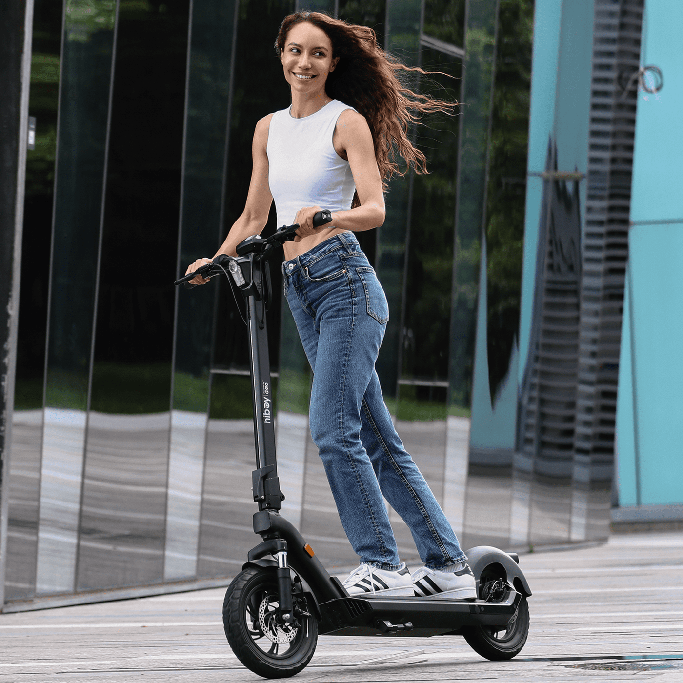 Woman riding an electric scooter in an urban setting