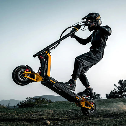 Person riding a black and yellow scooter in an outdoor setting