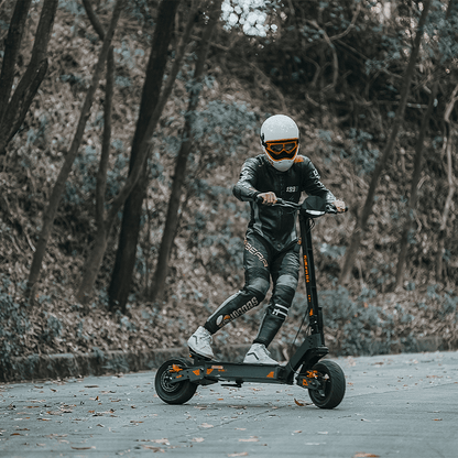 Person riding an electric scooter in a forested area