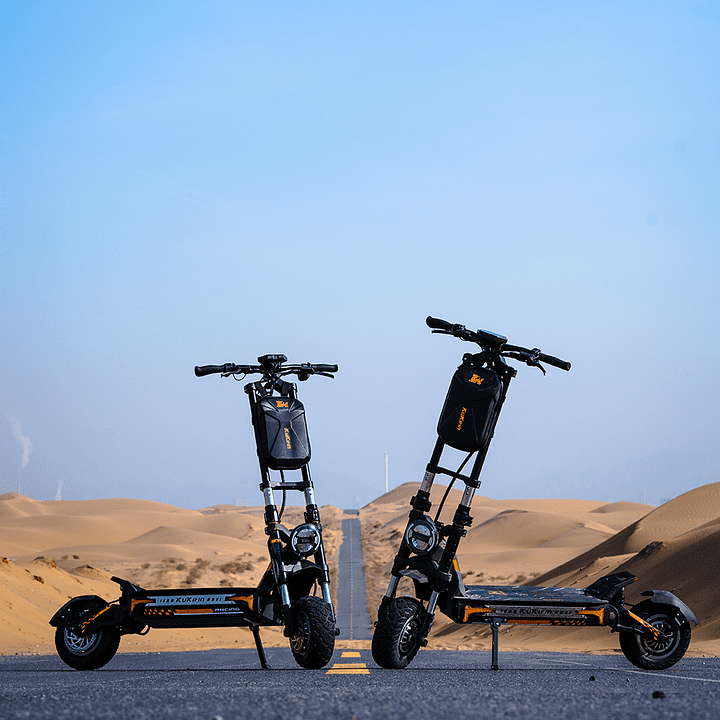 Two electric scooters on a road with desert landscape and clear blue sky in the background
