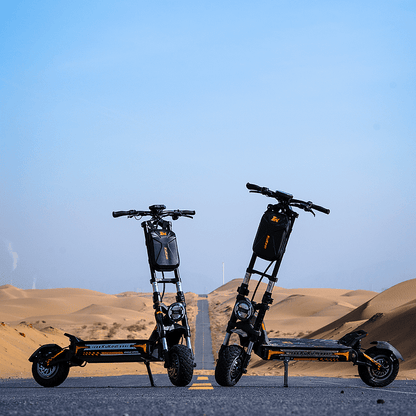 Two electric scooters on a road with desert landscape and clear blue sky in the background