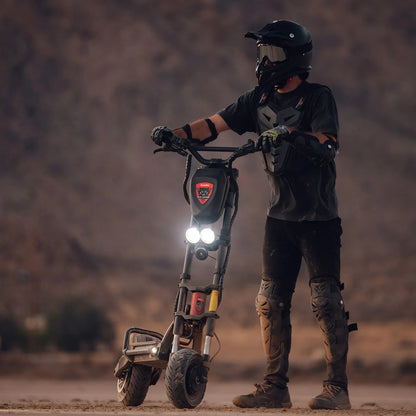 Person on a electric scooter in a desert setting with mountains in the background
