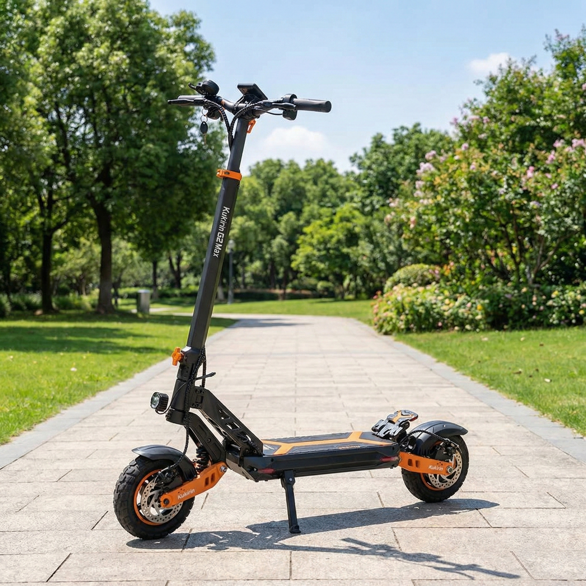Electric scooter on a paved path in a park with trees and flowers in the background