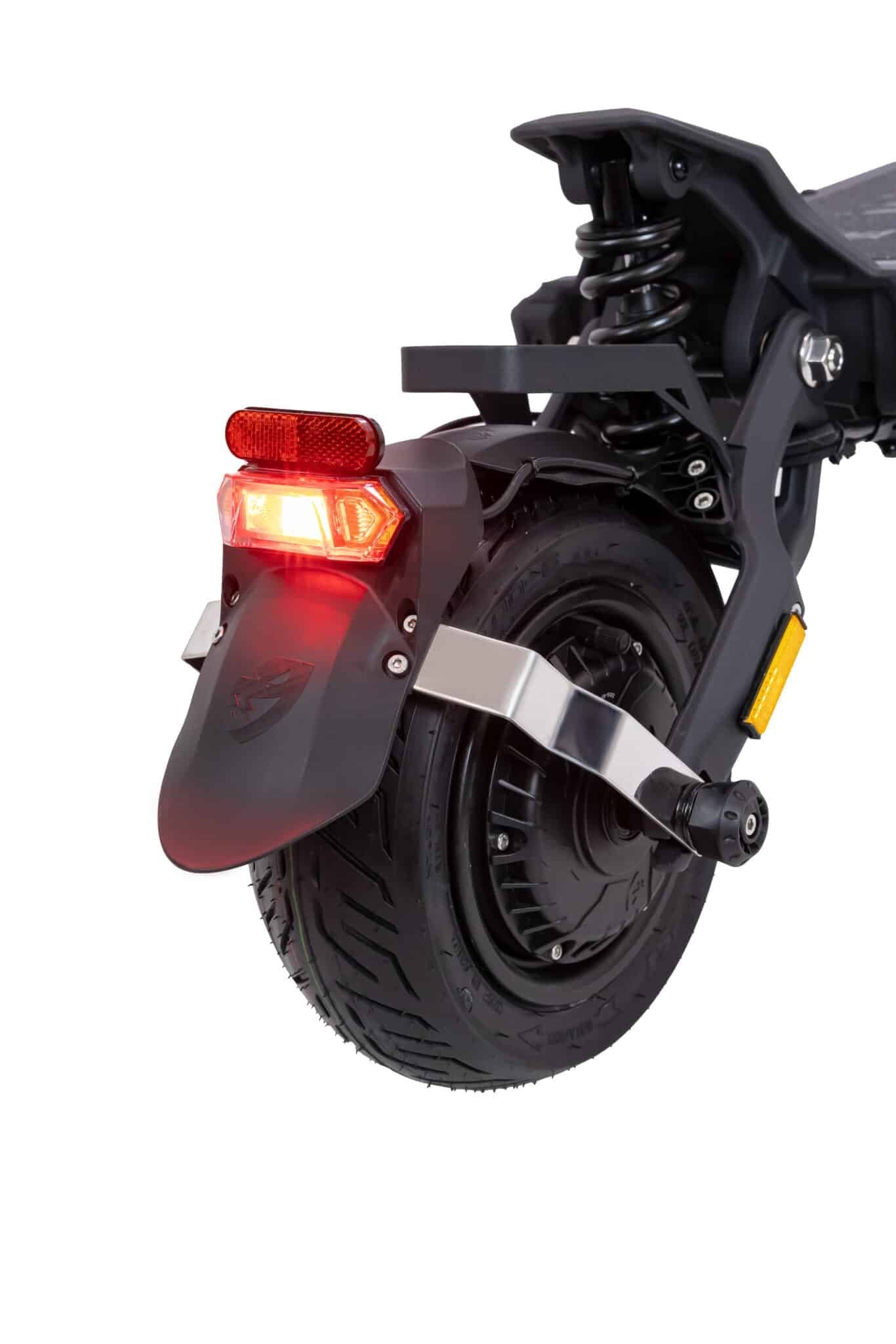 Close-up of a scooter's rear wheel and light on a white background