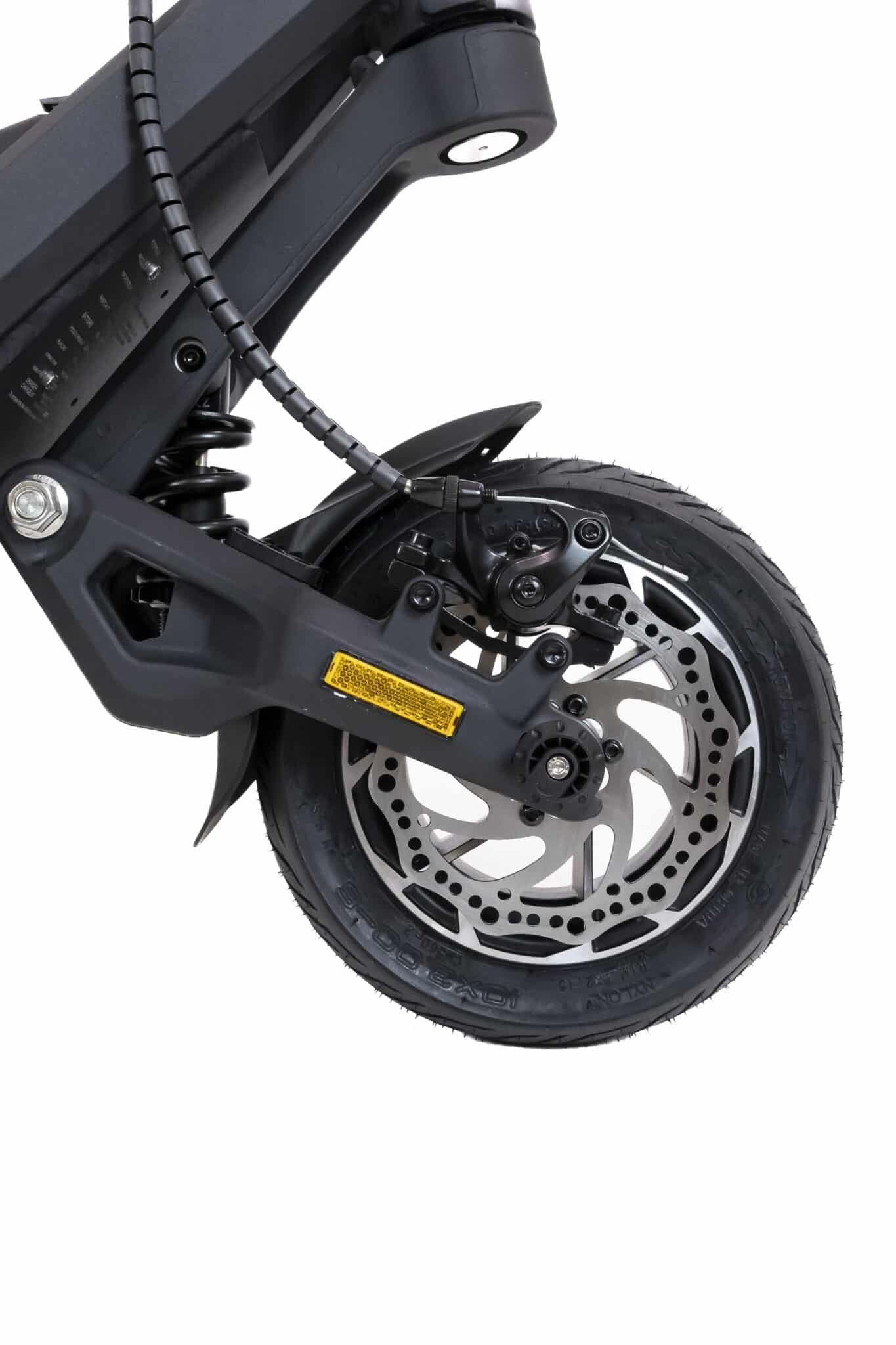 Close-up of a scooter wheel with suspension and disc brake on a white background