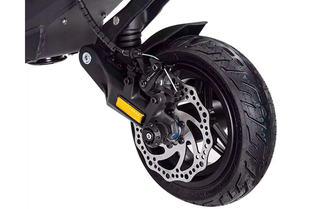 Close-up of a motorcycle wheel with disc brake on a white background