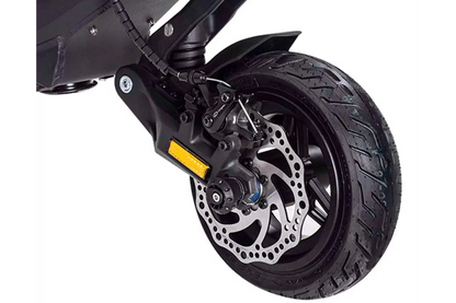 Close-up of a motorcycle wheel with disc brake on a white background