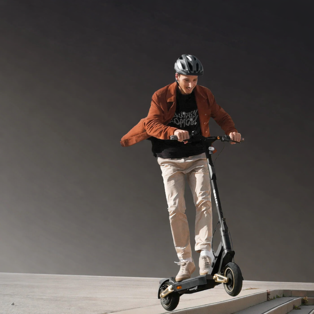 Person riding an electric scooter on a gray background