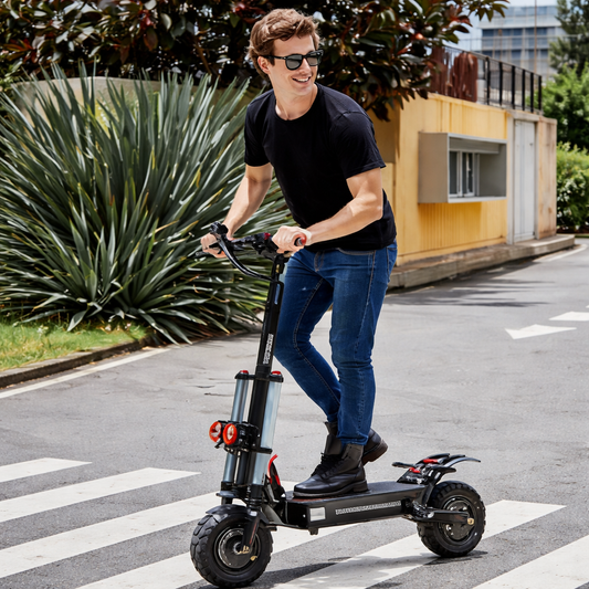 Man riding an electric scooter on a city street with plants and buildings in the background