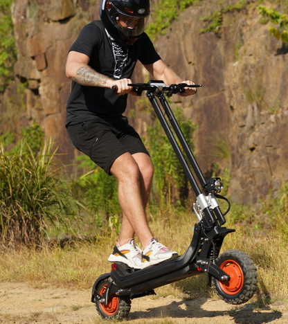 Rider on the Riding’times G63 dual motor electric scooter on a rocky trail