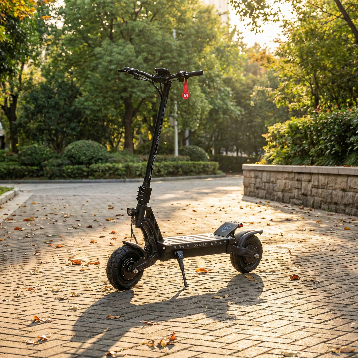 Black electric scooter on a paved path with trees in the background