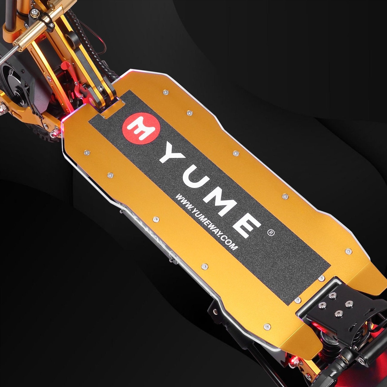 Close-up of a yellow and black scooter with 'YUME' branding on a dark background