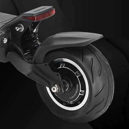 Close-up of a scooter wheel with visible branding on a dark background