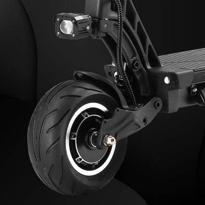 Close-up of a scooter wheel and suspension system on a black background