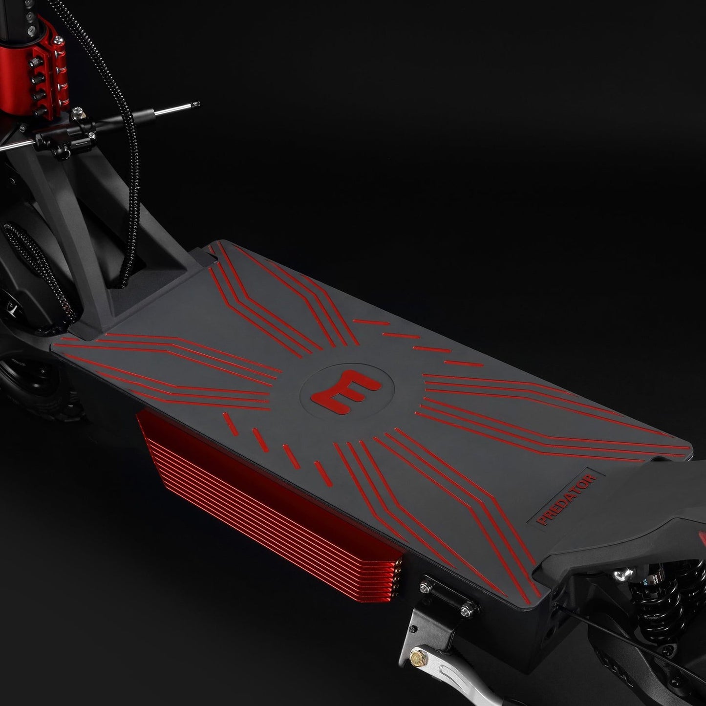 Close-up of a scooter deck with red accents on a black background