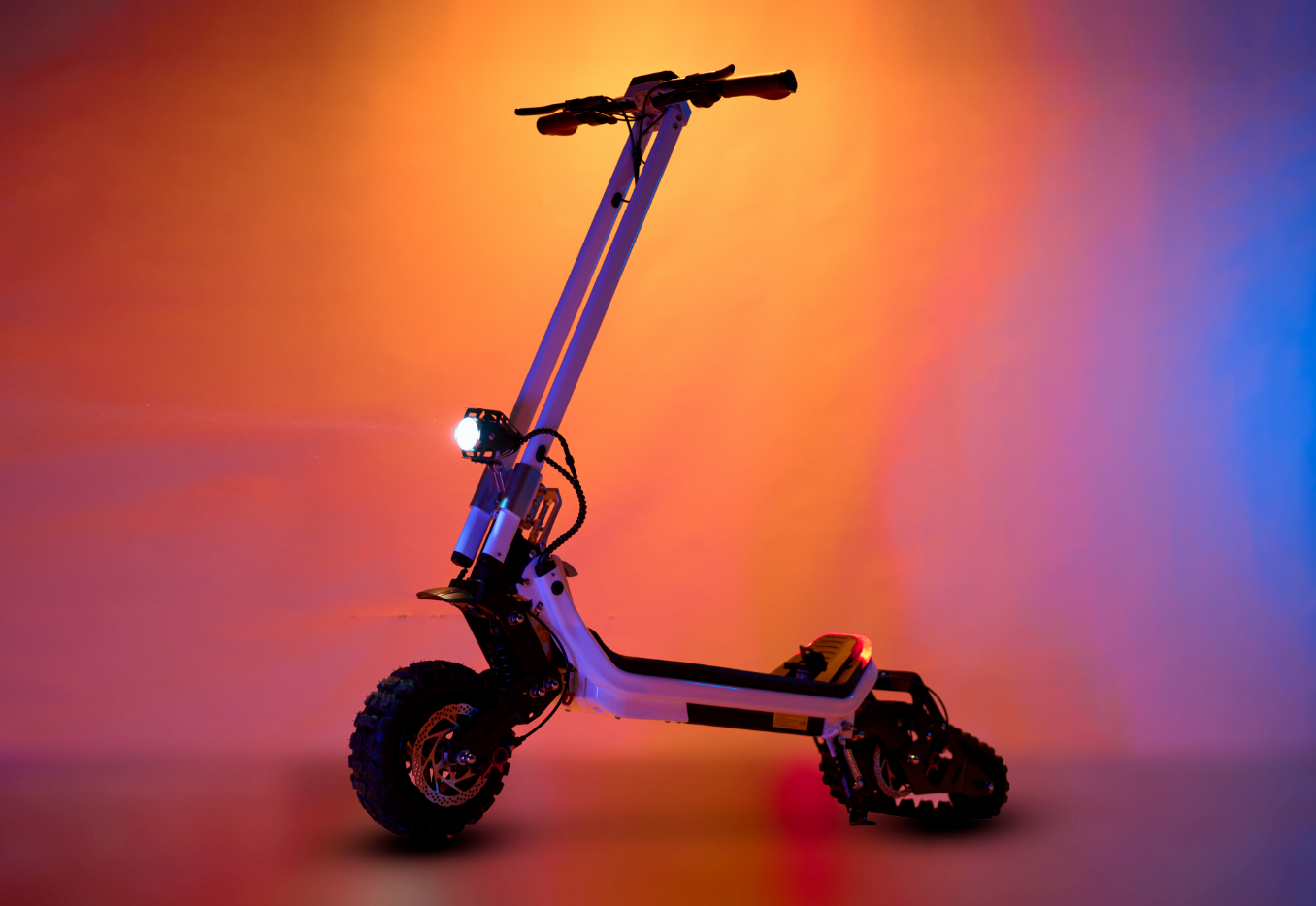 Riding’times G63 Convertible electric scooter lit in orange and blue studio light