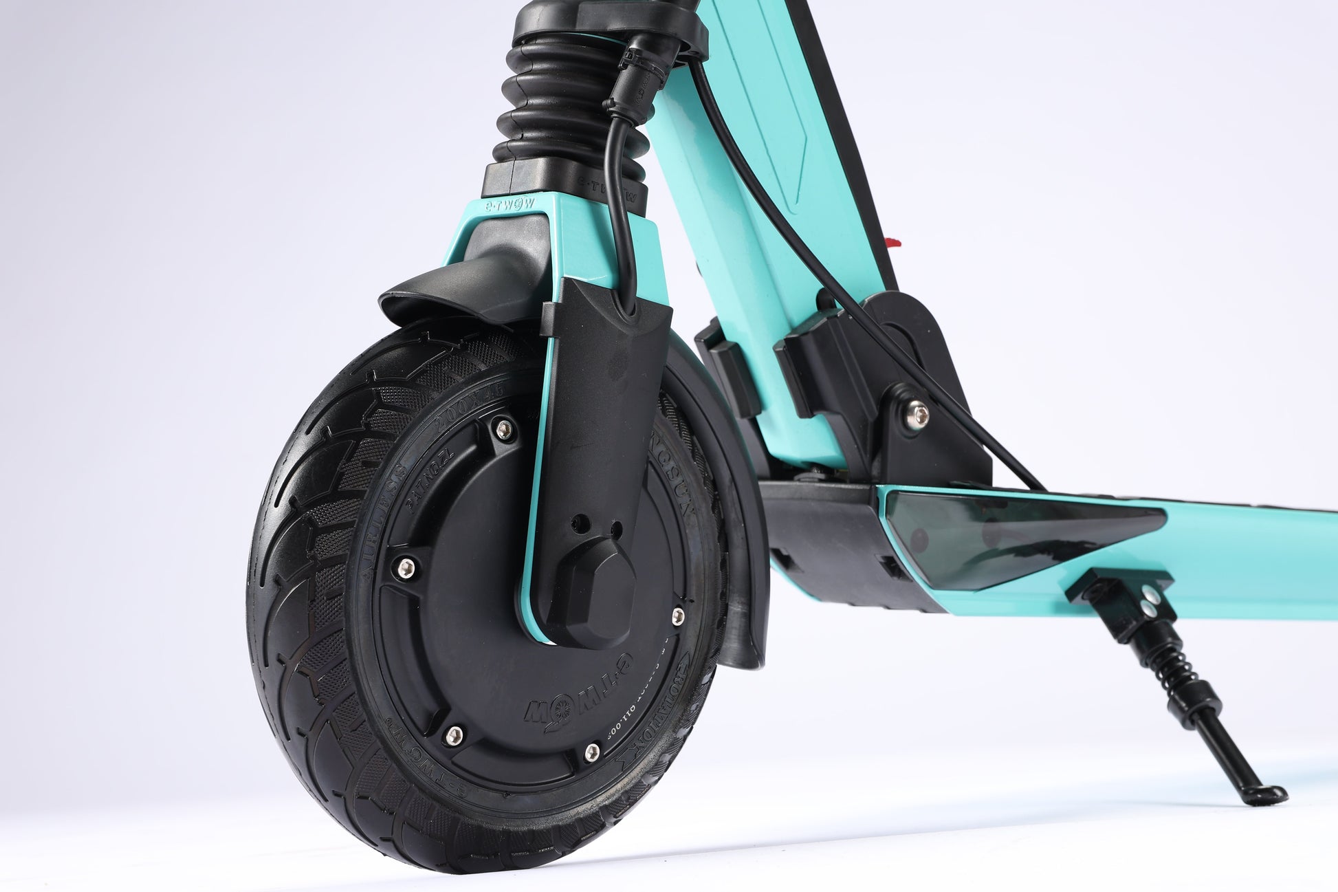 Close-up of a turquoise electric scooter with a black wheel on a white background