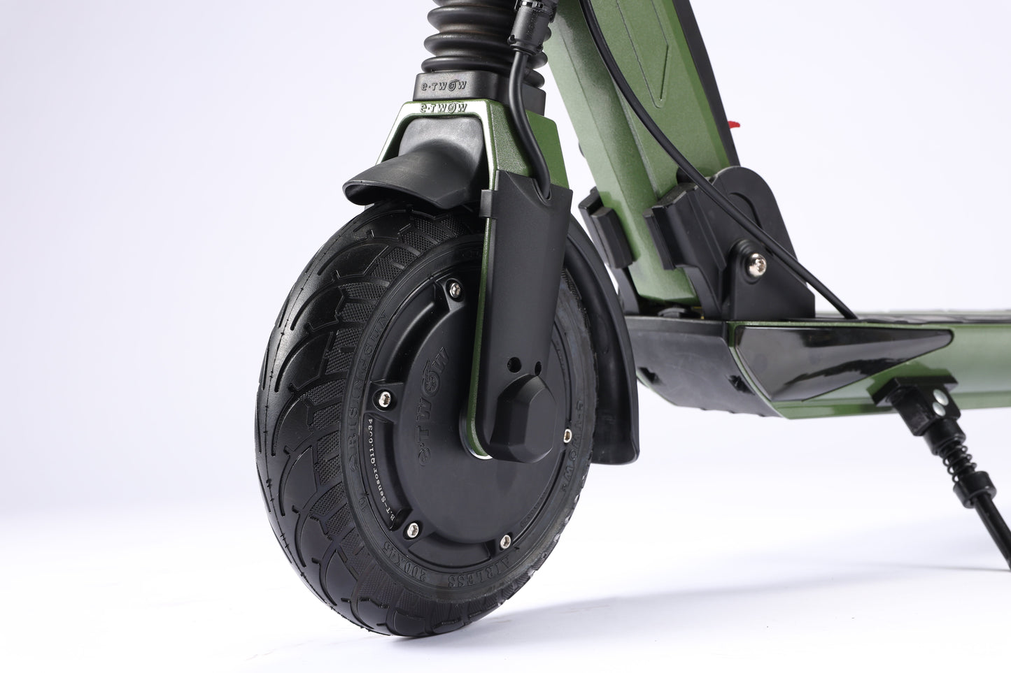 Close-up of a green electric scooter wheel on a white background