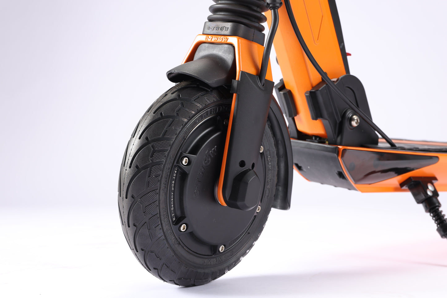 Close-up of an orange electric scooter with a black wheel on a white background