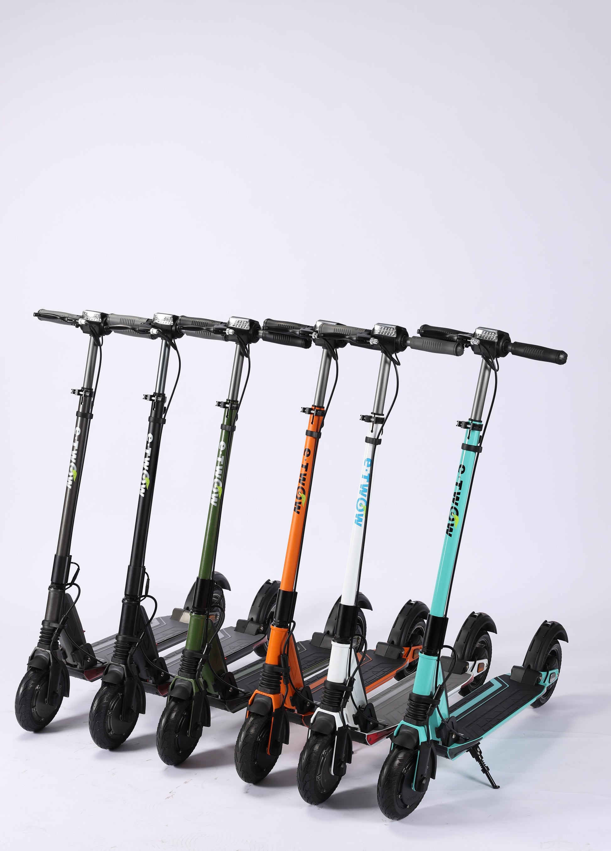 Row of electric scooters in various colors on a white background