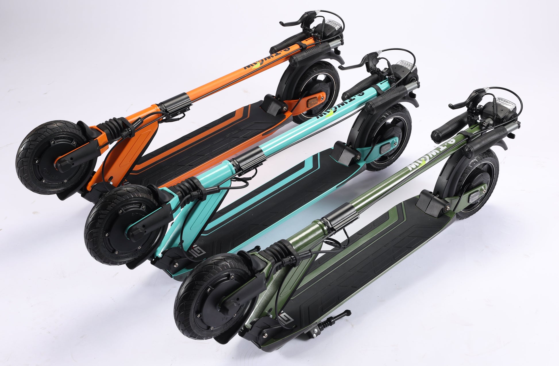Three folded electric scooters in orange, teal, and green on a white background