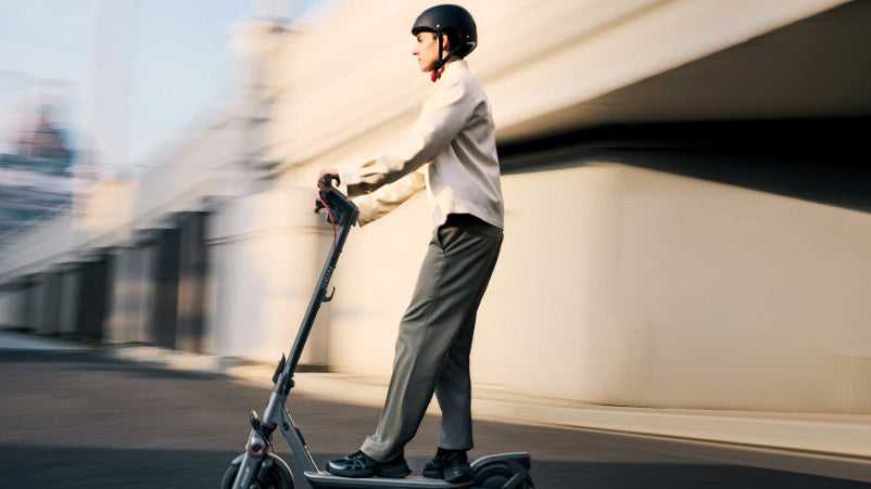 Person riding an electric scooter on a city street