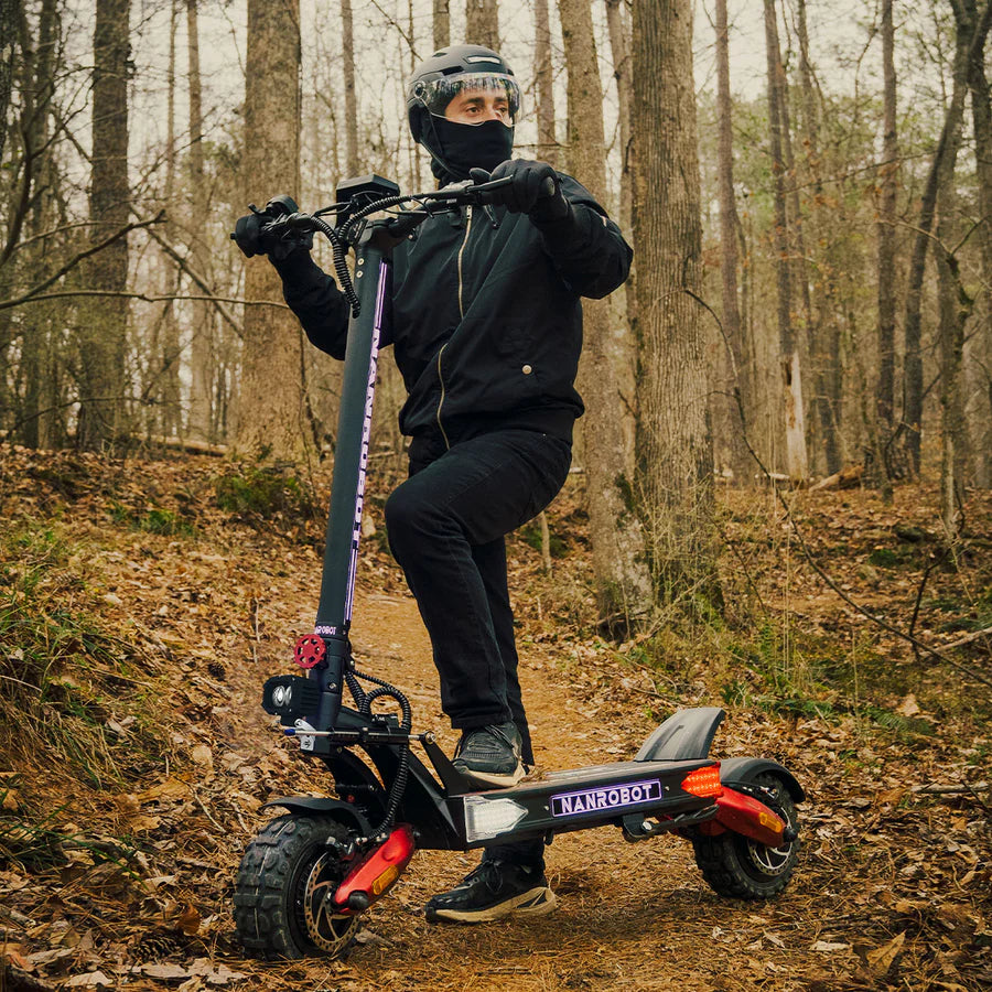 Person riding an electric scooter in a forest